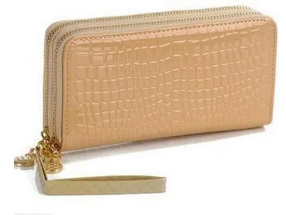 Black leather long bifold wallet on neutral background showing front with snap closure and card slots