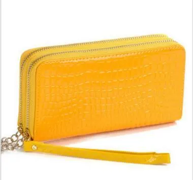 Black leather long bifold wallet on neutral background showing front with snap closure and card slots