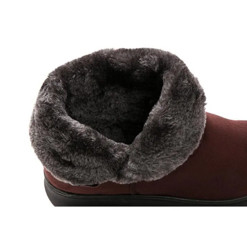 Women's winter flock ankle snow boots with button closure, rubber sole, and low platform in solid colour