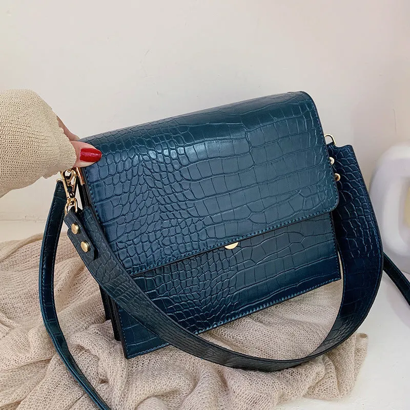 Stone pattern small square PU shoulder bag with flap closure and double straps, shown in blue, black, bronze, and yellow colour options