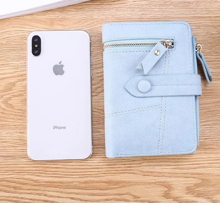 Vegan woman faux leather short wallet with zipper closure in solid colour, showing interior with bill and card compartments