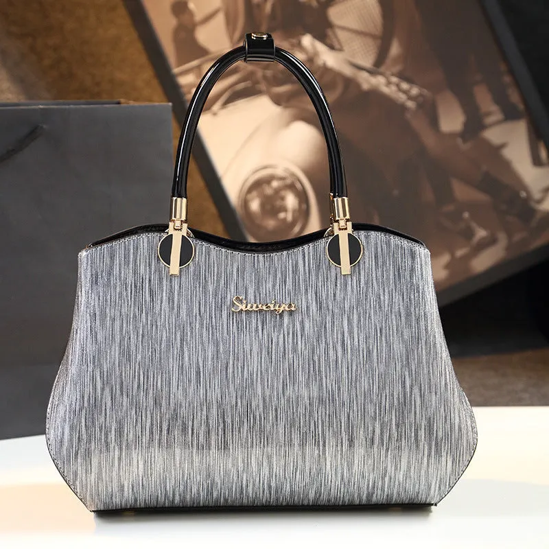 Women's medium horizontal square handbag with zipper closure and printed design, available in multiple colour options