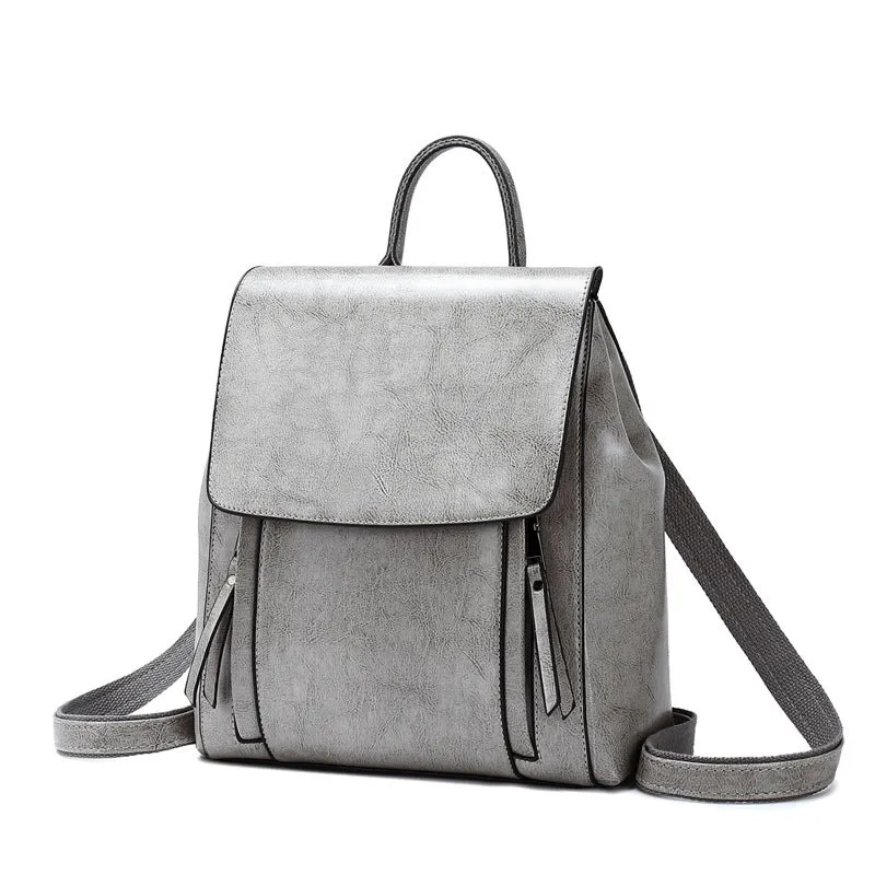 Large black square leather women's backpack with double straps and a cover opening.