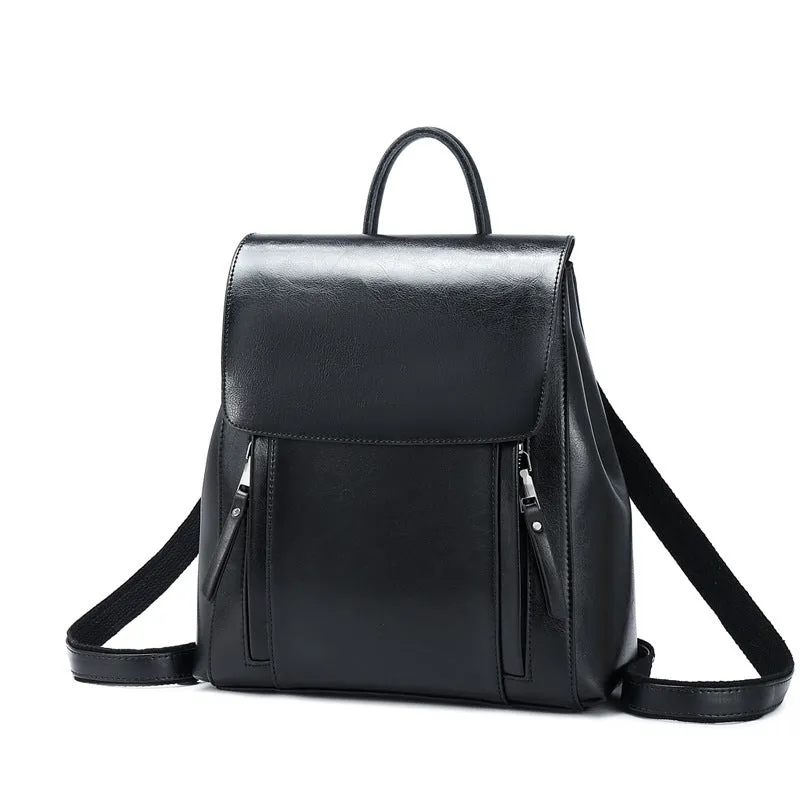 Large black square leather women's backpack with double straps and a cover opening.