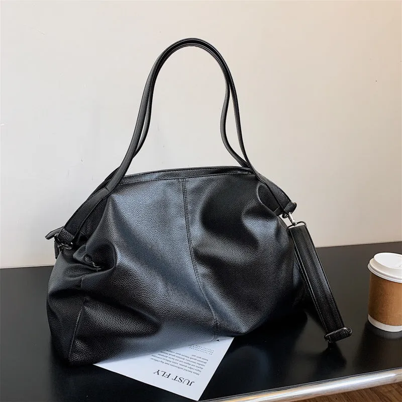 Soft surface PU leather messenger tote bag in a horizontal square shape with an adjustable shoulder strap.