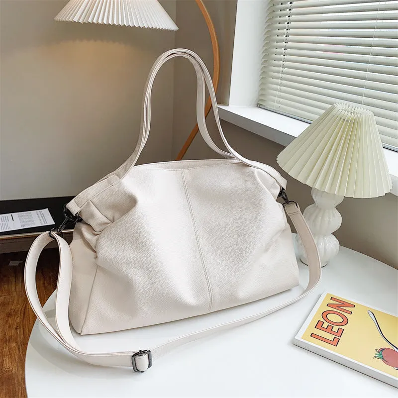Soft surface PU leather messenger tote bag in a horizontal square shape with an adjustable shoulder strap.
