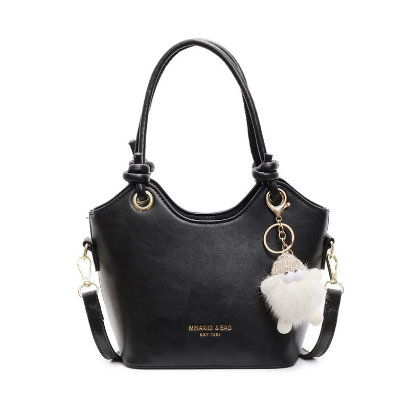 Small square PU crossbody bag in solid colour with zipper closure and single shoulder strap