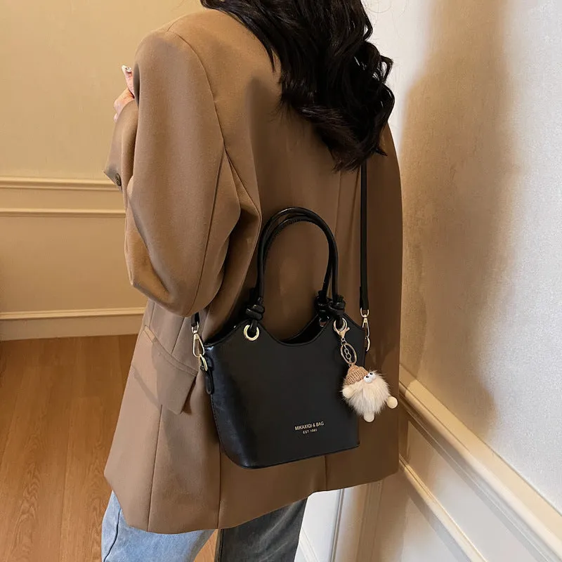 Small square PU crossbody bag in solid colour with zipper closure and single shoulder strap