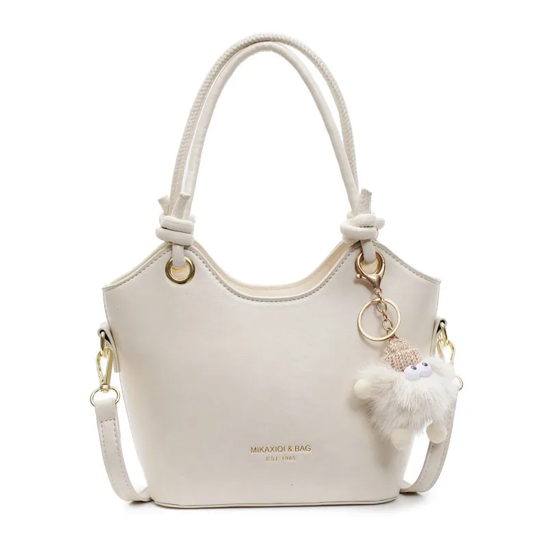 Small square PU crossbody bag in solid colour with zipper closure and single shoulder strap