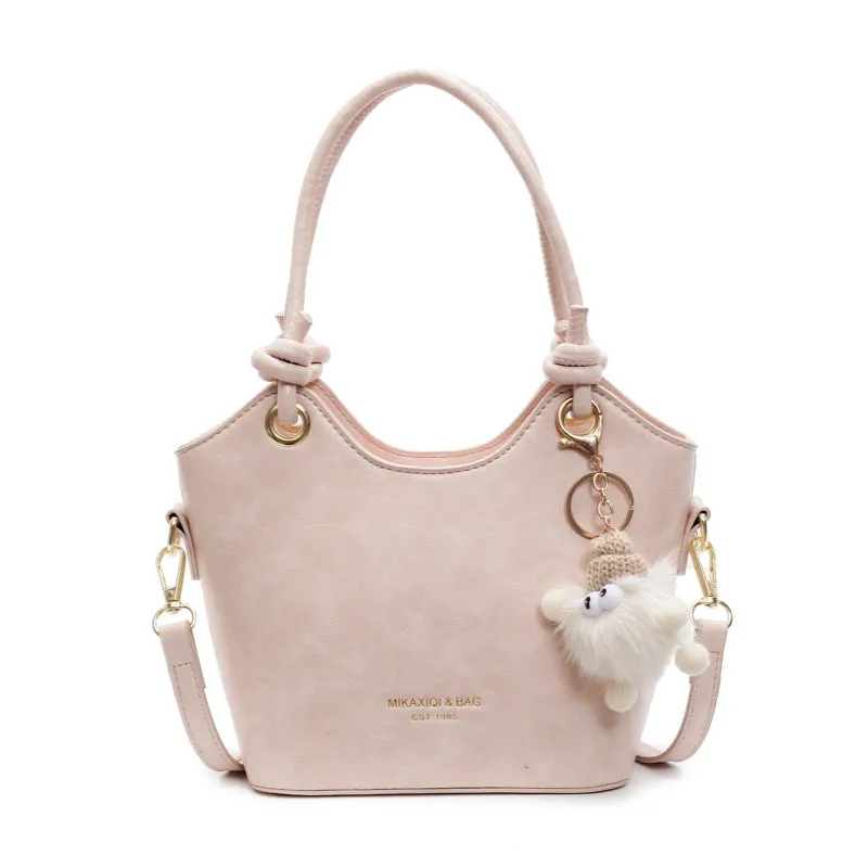 Small square PU crossbody bag in solid colour with zipper closure and single shoulder strap