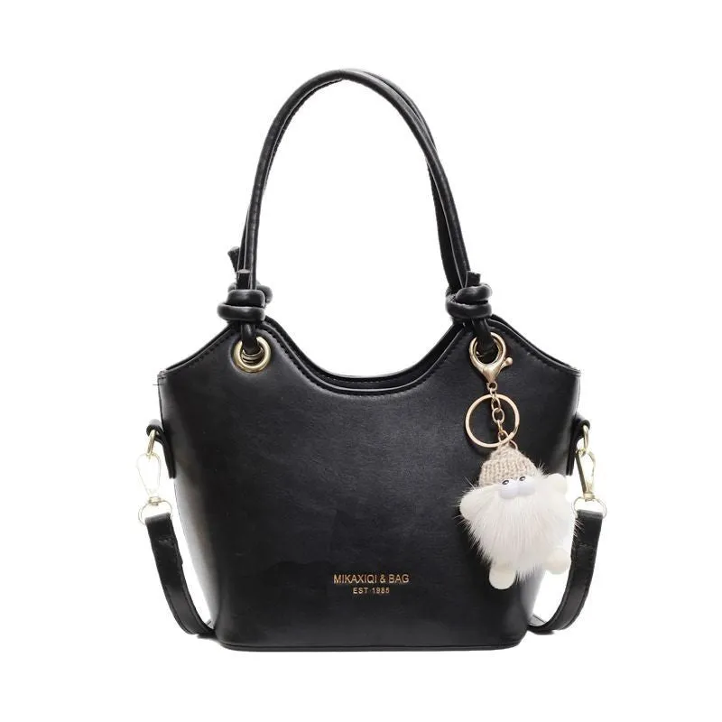 Small square PU crossbody bag in solid colour with zipper closure and single shoulder strap