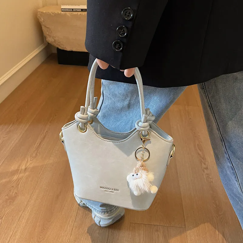Small square PU crossbody bag in solid colour with zipper closure and single shoulder strap