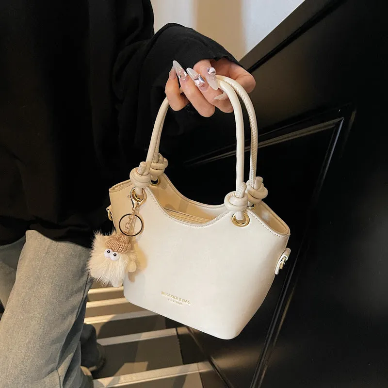 Small square PU crossbody bag in solid colour with zipper closure and single shoulder strap