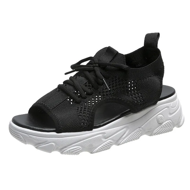 Lace-up sandals for women with thick rubber sole and mesh upper in orange colour, flat design