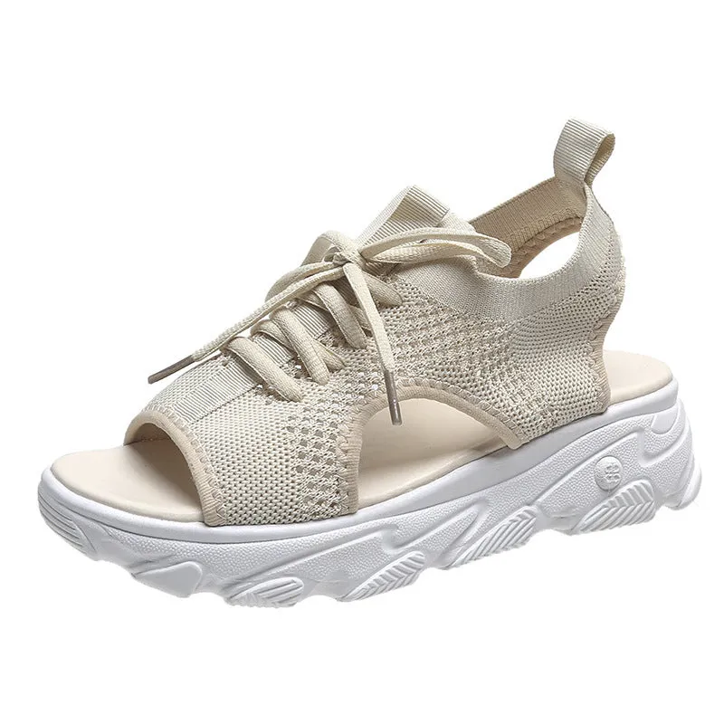 Lace-up sandals for women with thick rubber sole and mesh upper in orange colour, flat design