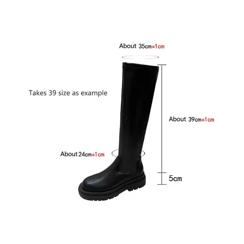 Black women's knee high boots with thick chunky sole and round toe on a winter background