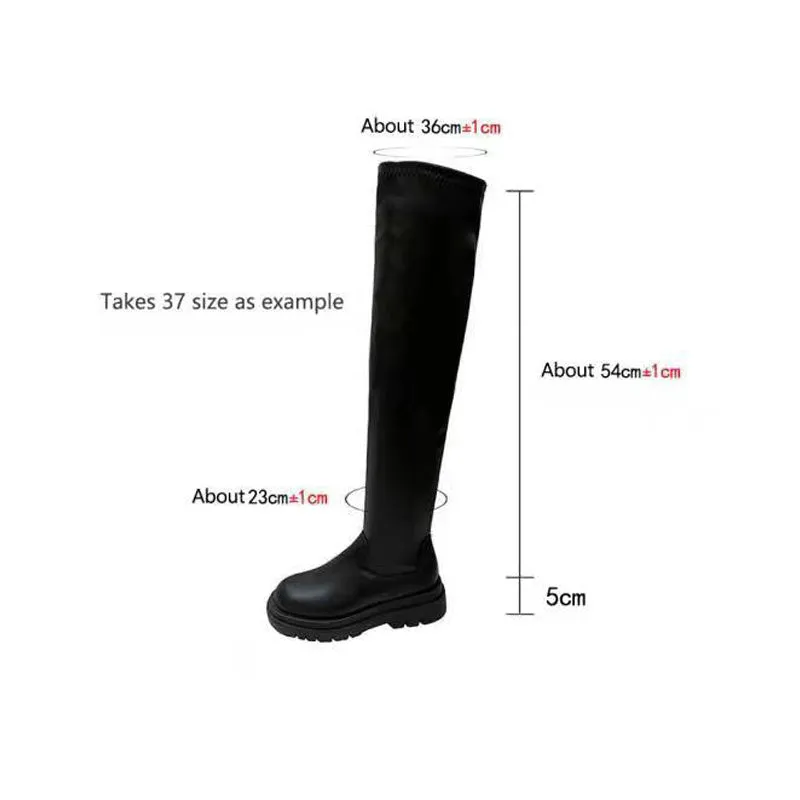Black women's knee high boots with thick chunky sole and round toe on a winter background