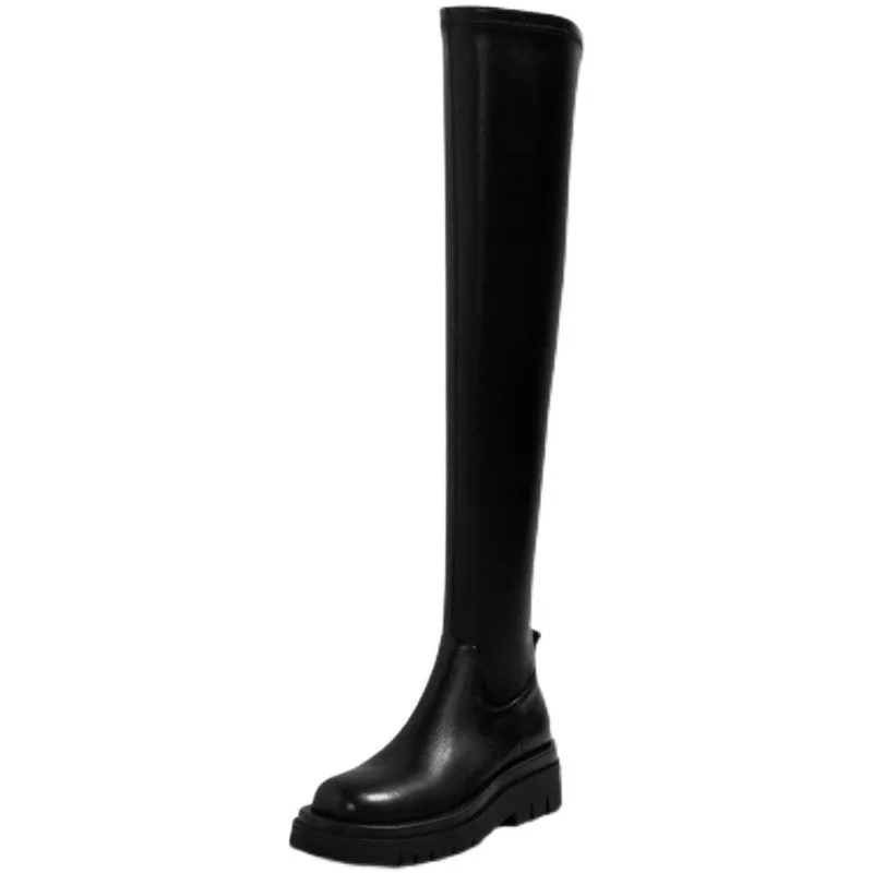 Black women's knee high boots with thick chunky sole and round toe on a winter background