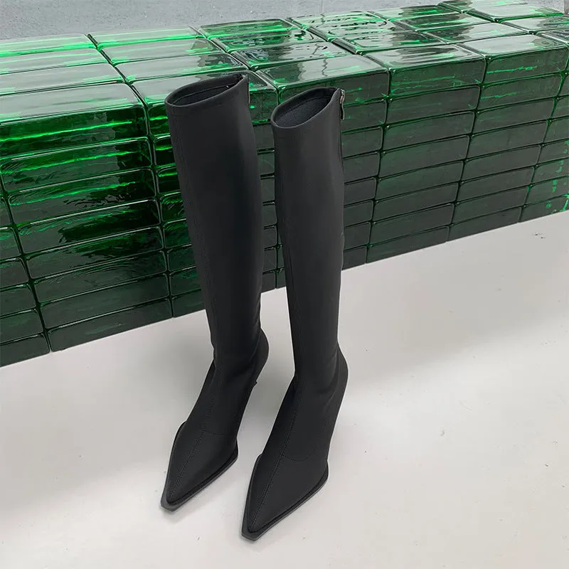 Women's black pointed toe below knee stiletto heel boots with a back zipper on display.