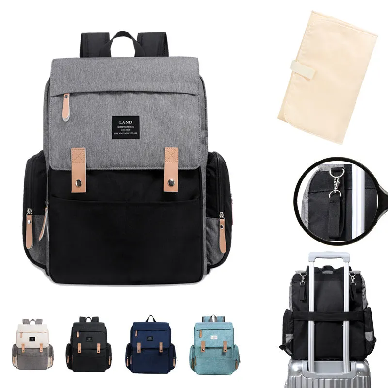 LAND Mommy large grey Oxford cloth diaper backpack with changing mat, shown on a table