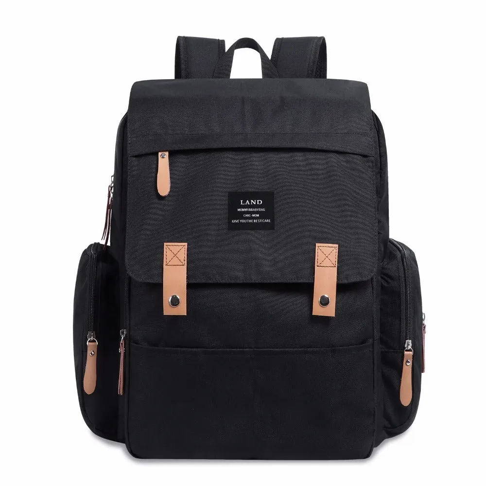 LAND Mommy large grey Oxford cloth diaper backpack with changing mat, shown on a table