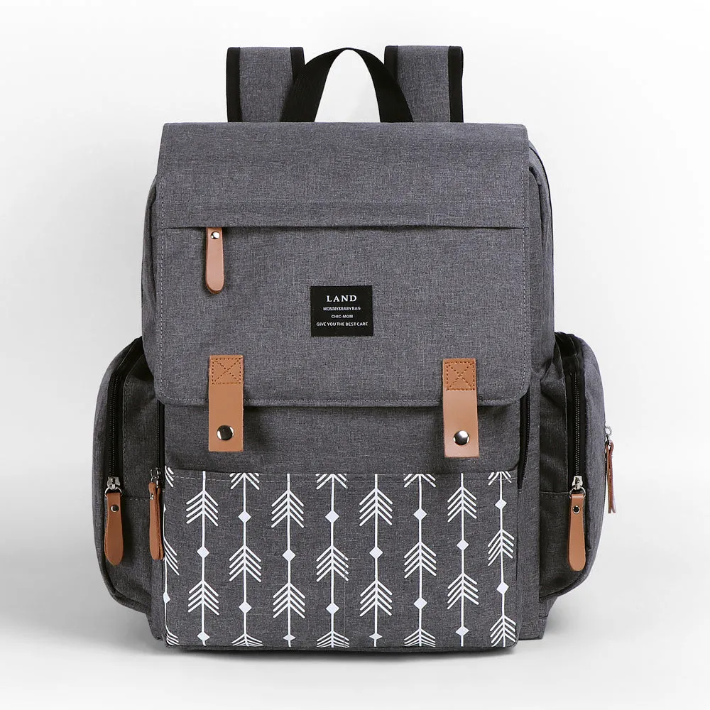 LAND Mommy large grey Oxford cloth diaper backpack with changing mat, shown on a table