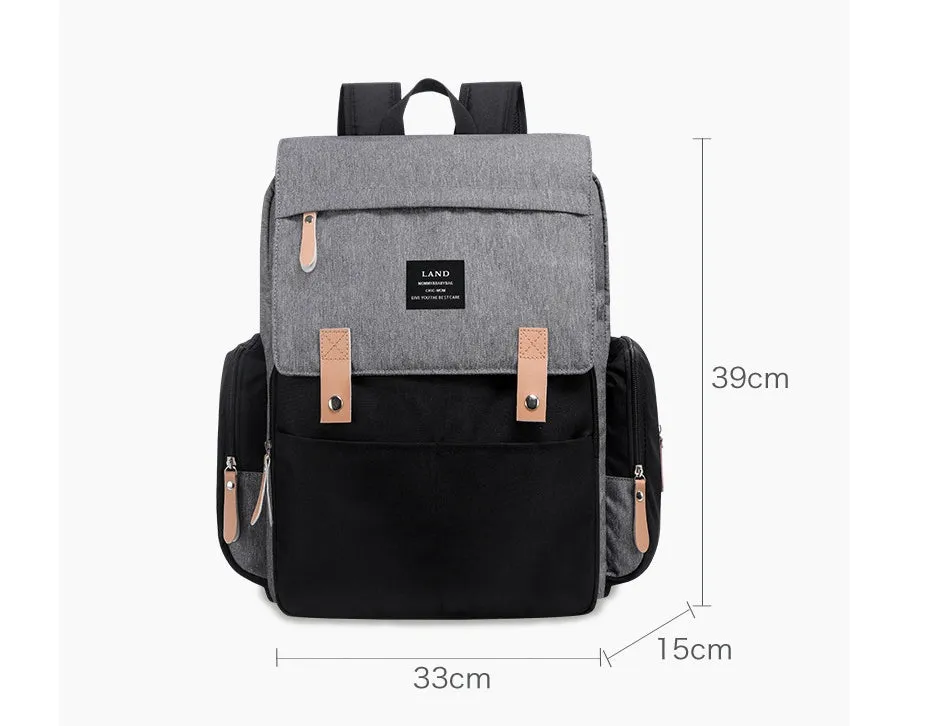 LAND Mommy large grey Oxford cloth diaper backpack with changing mat, shown on a table