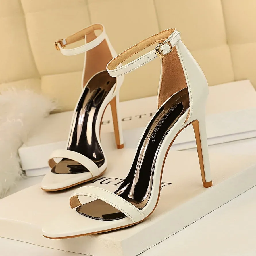 Women's open toe ankle-strap high heels with a buckle fastening, shown in one of six available colours.