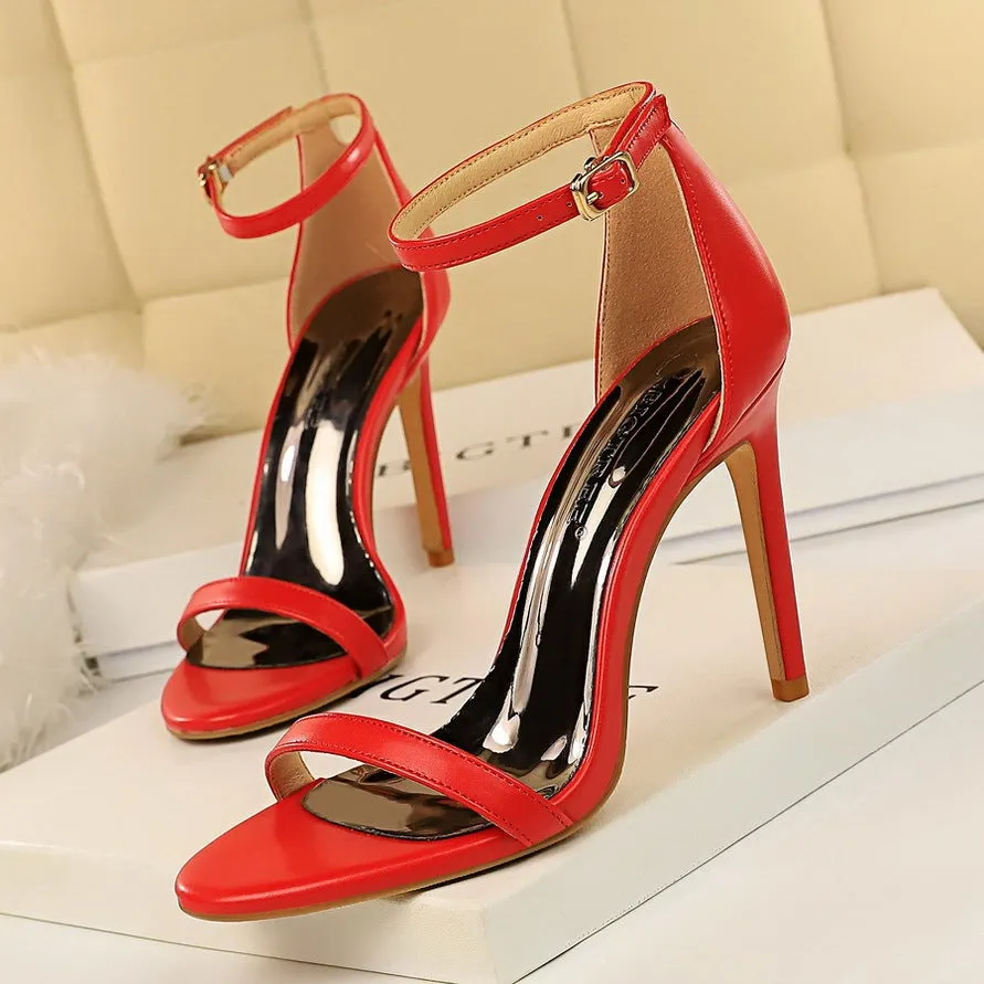 Women's open toe ankle-strap high heels with a buckle fastening, shown in one of six available colours.