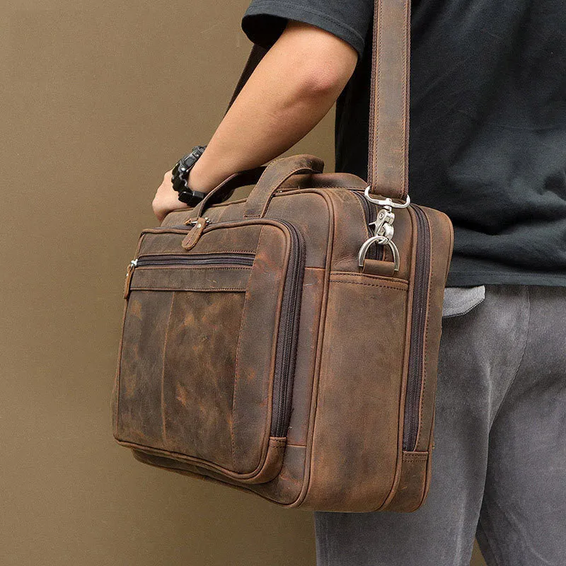 Men's dark brown Crazy Horse leather laptop bag with double handles and zip closure on a neutral background