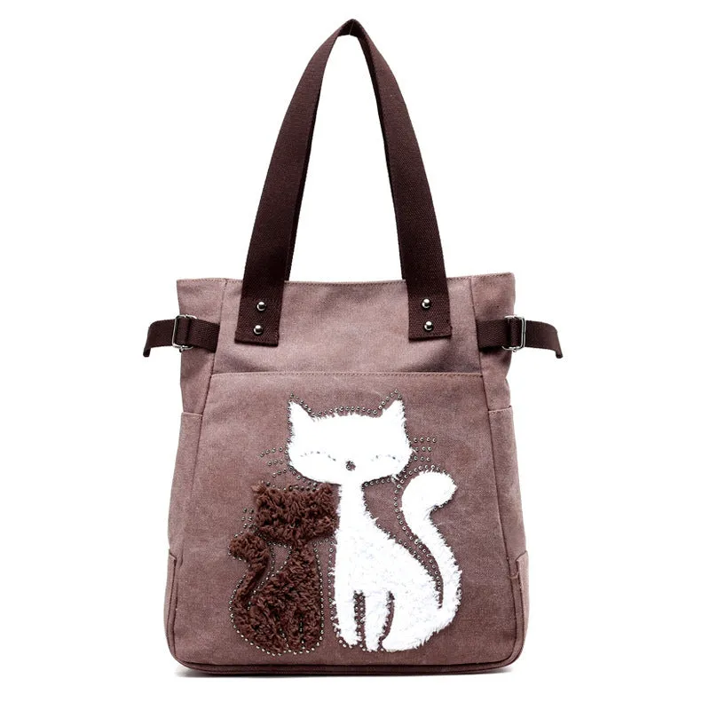 KVKY canvas handbag with plush cat applique in beige colour on a woman's shoulder