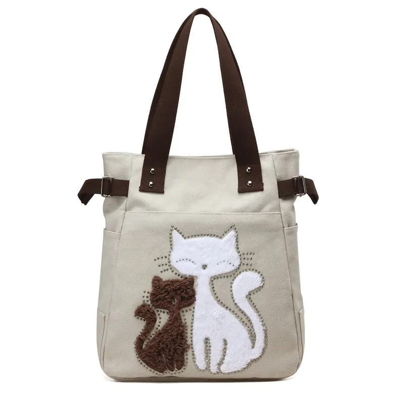 KVKY canvas handbag with plush cat applique in beige colour on a woman's shoulder