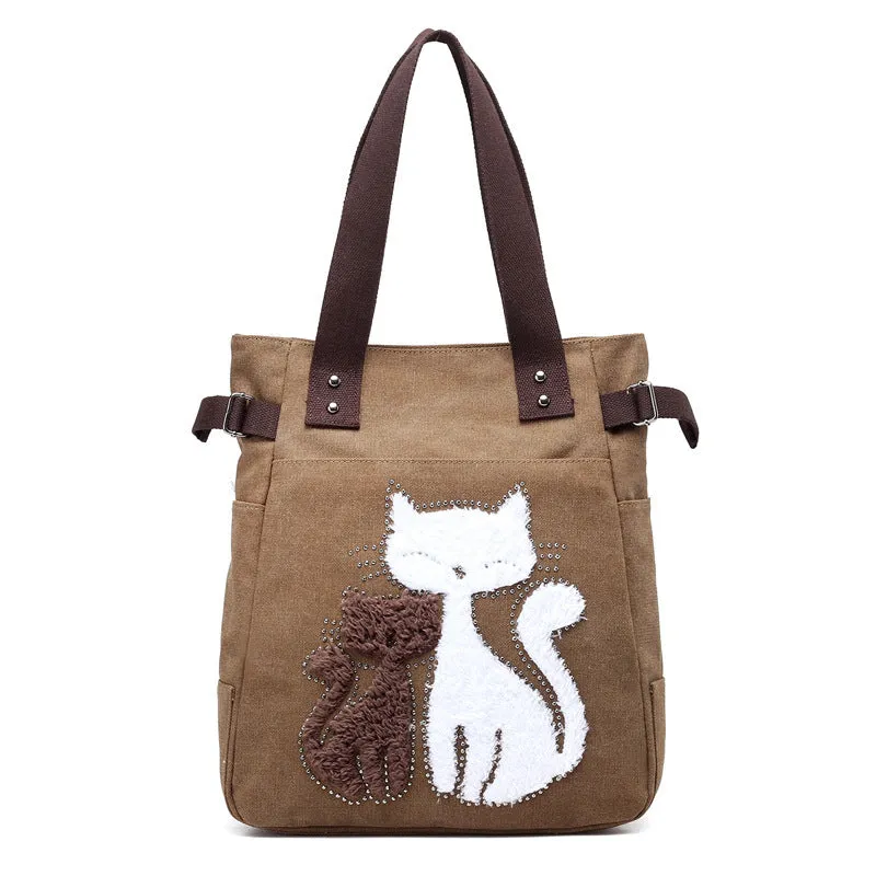 KVKY canvas handbag with plush cat applique in beige colour on a woman's shoulder