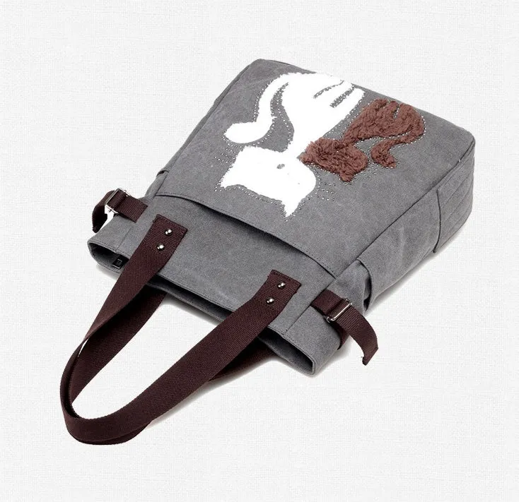 KVKY canvas handbag with plush cat applique in beige colour on a woman's shoulder