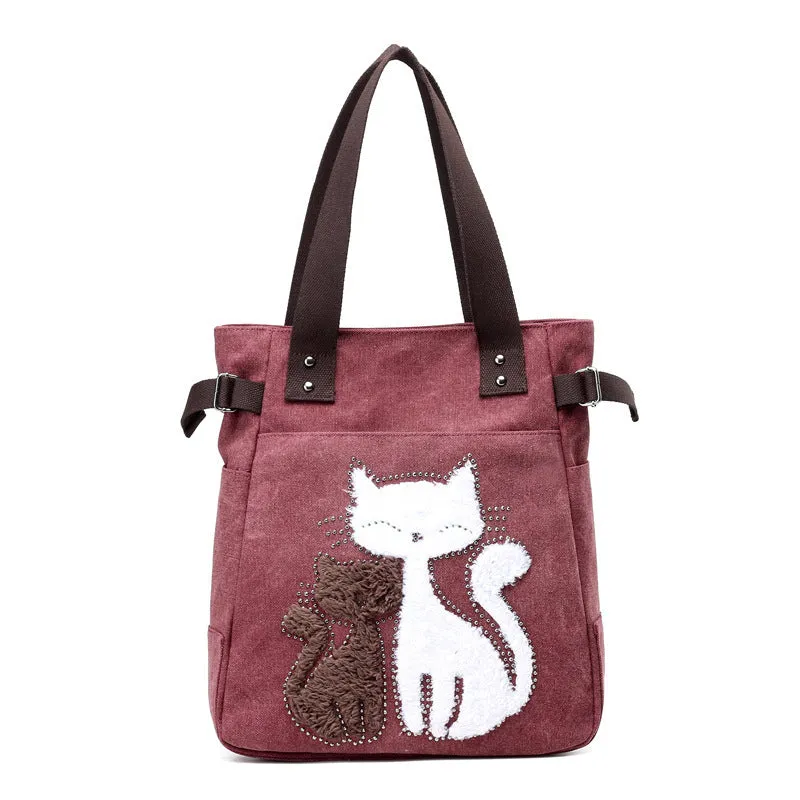 KVKY canvas handbag with plush cat applique in beige colour on a woman's shoulder