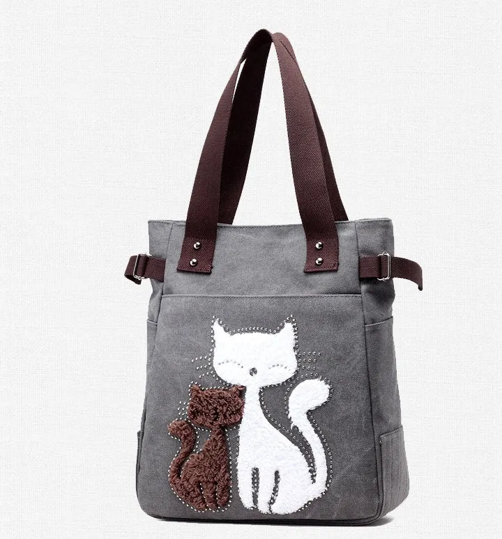 KVKY canvas handbag with plush cat applique in beige colour on a woman's shoulder