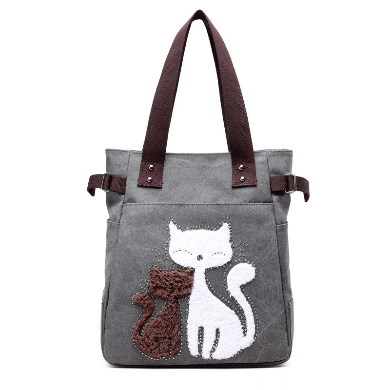 KVKY canvas handbag with plush cat applique in beige colour on a woman's shoulder