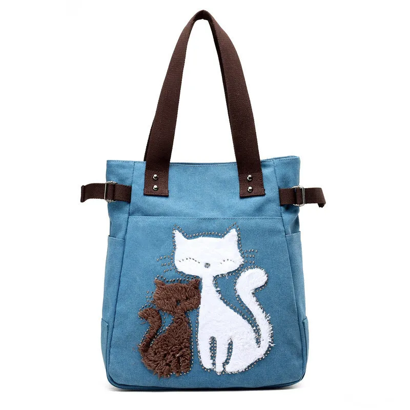 KVKY canvas handbag with plush cat applique in beige colour on a woman's shoulder