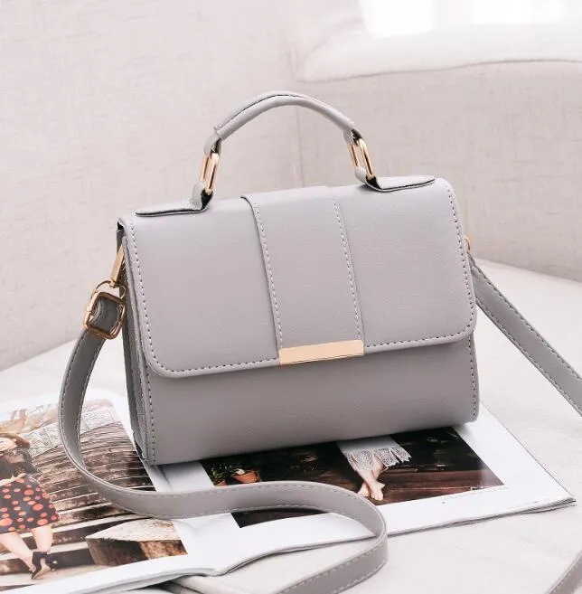 Fashion woman handbag in soft PU with shoulder strap, side view showing polyester lining