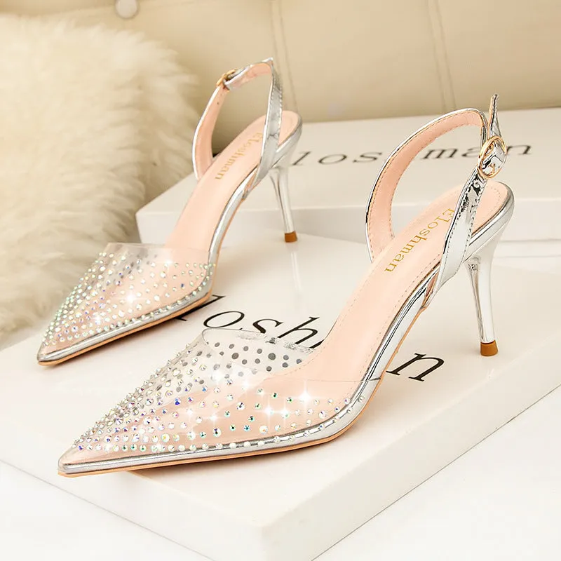 Women's black pointed low-cut stiletto high heels with buckle closure on a light background