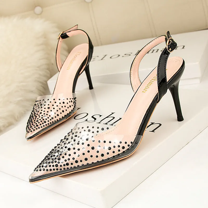 Women's black pointed low-cut stiletto high heels with buckle closure on a light background