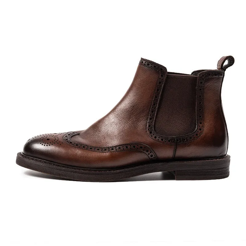 Men's black Chelsea boots with brogue carved genuine leather upper and rubber sole, side view
