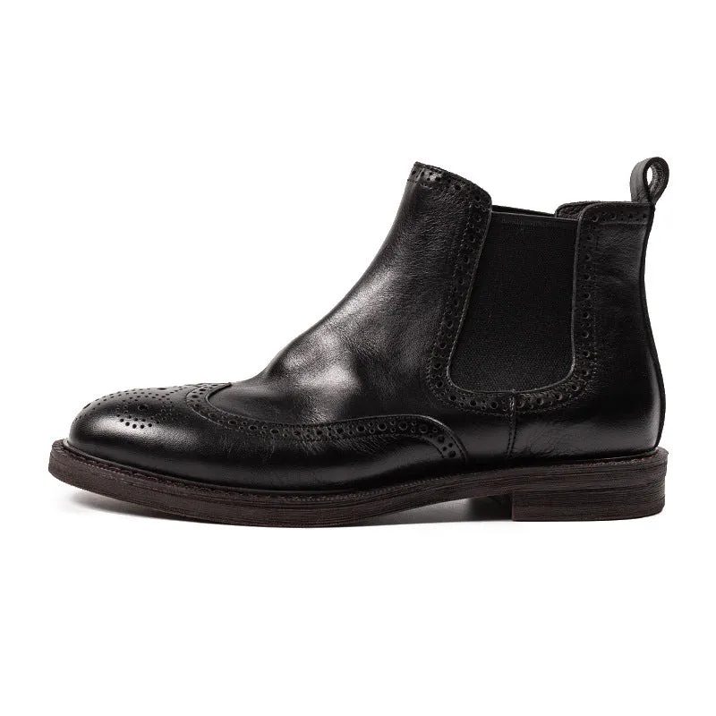 Men's black Chelsea boots with brogue carved genuine leather upper and rubber sole, side view