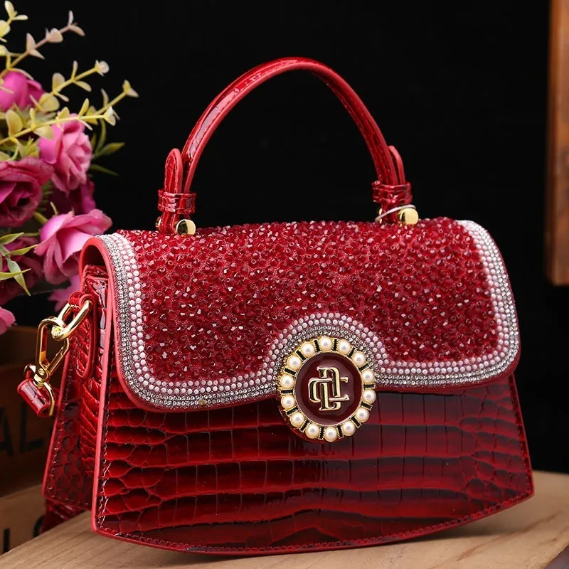 Patent leather diamond portable shoulder bag in black, brown, pink, and red with lock detail and single strap