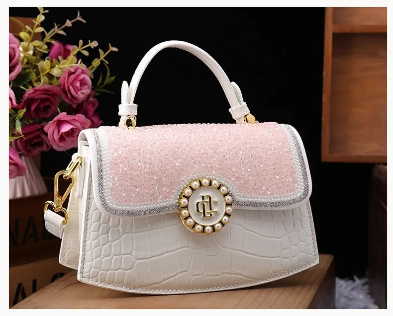 Patent leather diamond portable shoulder bag in black, brown, pink, and red with lock detail and single strap