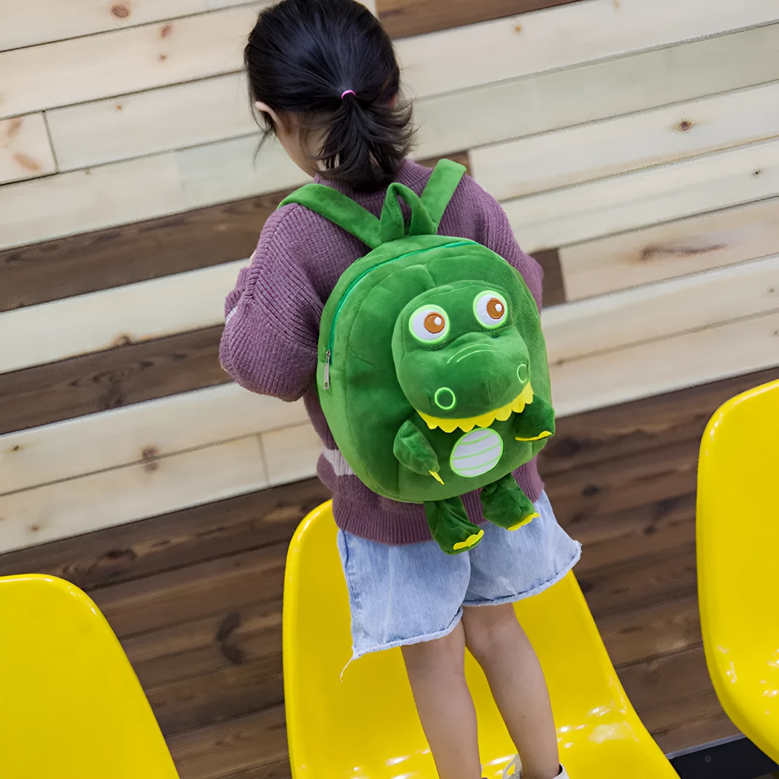 Soft plush dinosaur backpack for children with embroidery detailing in blue colour