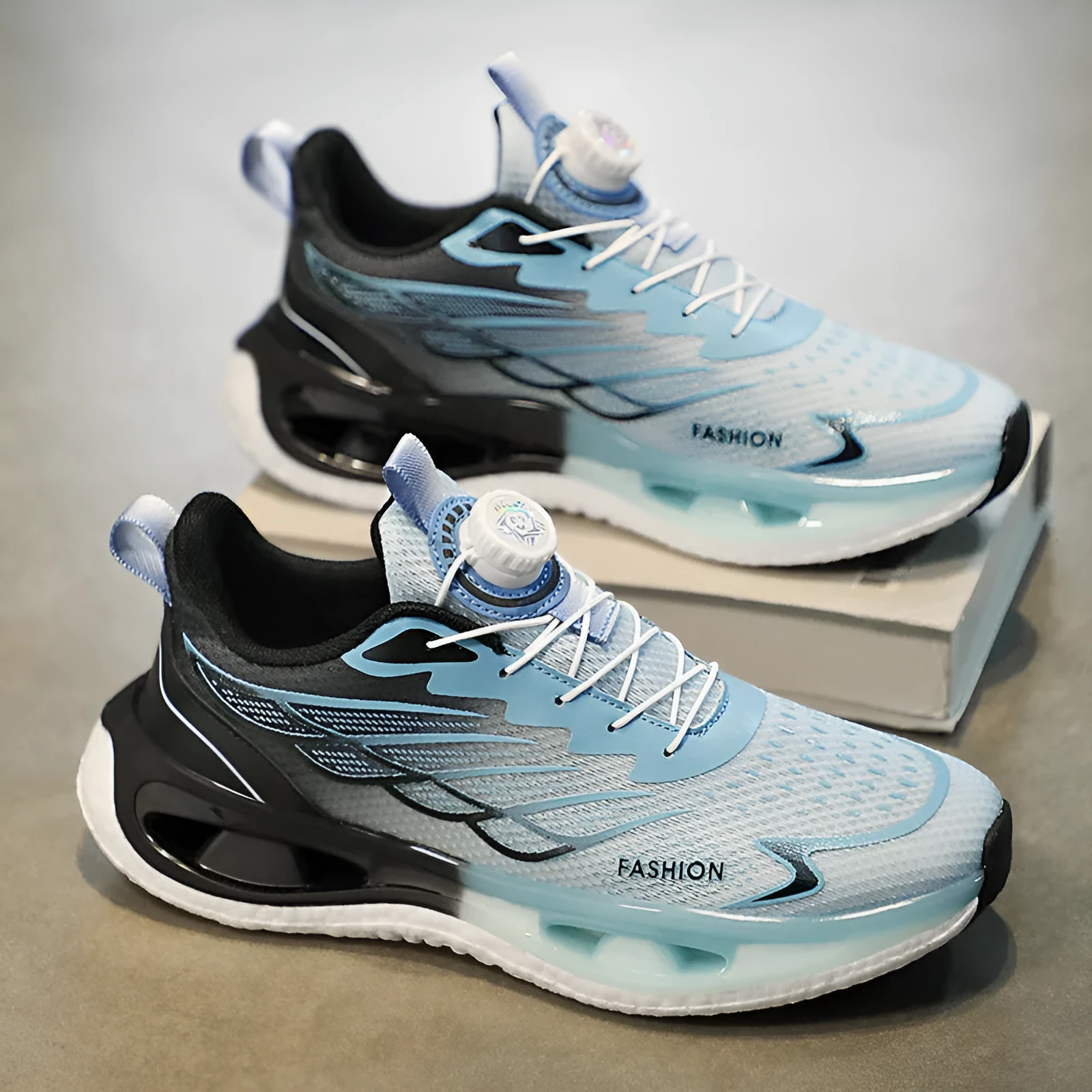 Low-top youth sneaker with rotating button closure in light blue mesh fabric and a non-slip rubber sole.