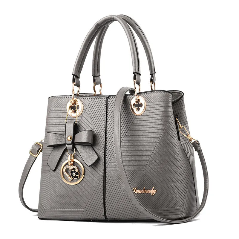 Retro style PU leather handbag with zipper opening and shoulder strap in multiple colours.