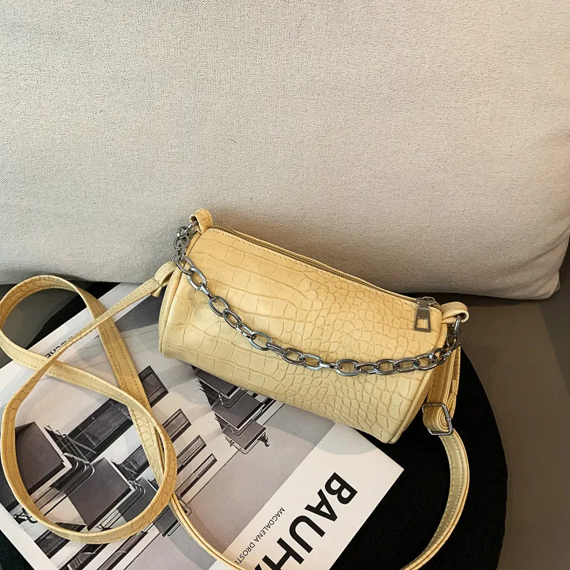 One shoulder cylinder messenger bag in beige PU leather with embossed crocodile pattern and zipper closure