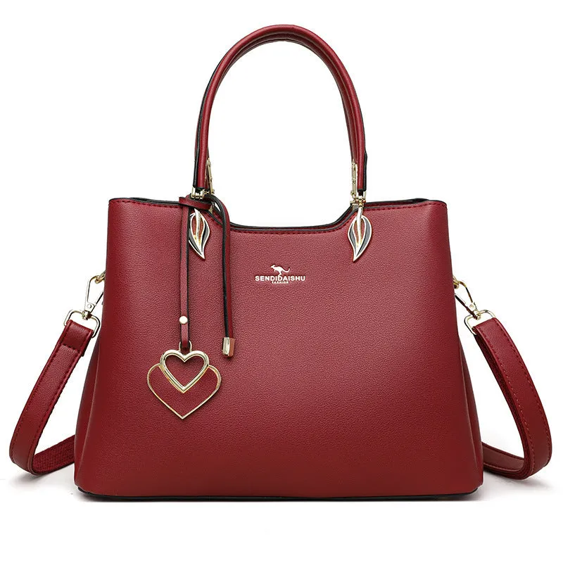 Women's black PU leather messenger bag with shoulder strap and sewing thread detail.